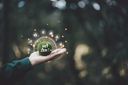 Net zero icon and carbon neutral concept in the hand for net zero greenhouse gas emissions target Climate neutral long term strategy on a green background. environmental icon, banner and copy spaceの写真素材
