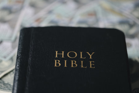 One tenth or tithe is basis on which Bible teaches us to give one tenth of first fruit to God. coins with Holy Bible. Biblical concept of Christian offering, generosity, and giving tithes in church.の写真素材