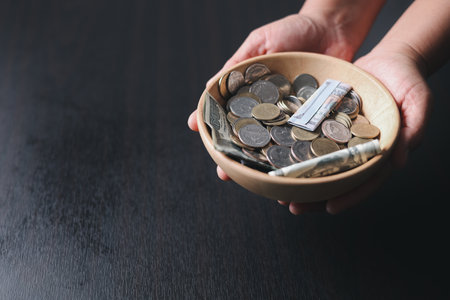 One tenth or tithe is basis on which Bible teaches us to give one tenth of first fruit to God. coins with Holy Bible. Biblical concept of Christian offering, generosity, and giving tithes in church.の写真素材