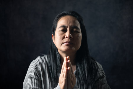 Christian life crisis prayer to god. Woman Pray for god blessing to wishing have a better life. woman hands praying to god with the bible. begging for forgiveness and believe in goodness.の写真素材