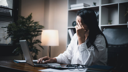 A woman battles depression and stress in her workplace, highlighting the challenges faced by professionals. This image captures the impact of mental health on employees in a corporate environment.の写真素材