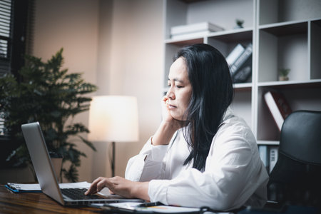 A woman battles depression and stress in her workplace, highlighting the challenges faced by professionals. This image captures the impact of mental health on employees in a corporate environment.の写真素材