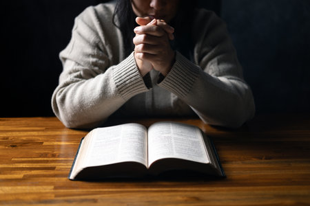 Christian life crisis prayer to god. Woman Pray for god blessing to wishing have a better life. woman hands praying to god with the bible. begging for forgiveness and believe in goodness.の写真素材