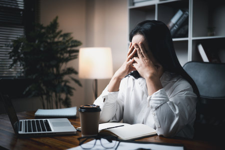 A woman battles depression and stress in her workplace, highlighting the challenges faced by professionals. This image captures the impact of mental health on employees in a corporate environment.の写真素材