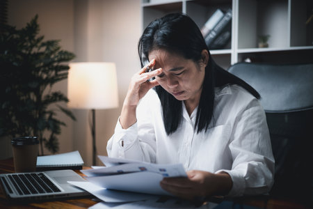A woman battles depression and stress in her workplace, highlighting the challenges faced by professionals. This image captures the impact of mental health on employees in a corporate environment.の写真素材