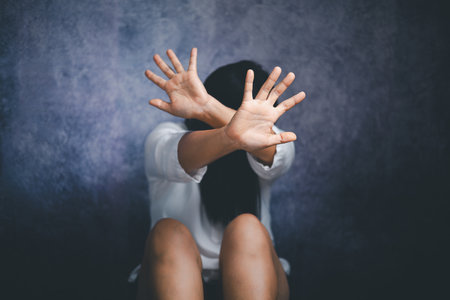 Stop violence against Women, international women's day. Young depressed woman, domestic and rape violence,beaten and raped sitting in the corner.の写真素材