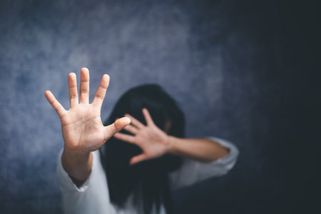 Stop violence against Women, international women's day. Young depressed woman, domestic and rape violence,beaten and raped sitting in the corner.の写真素材