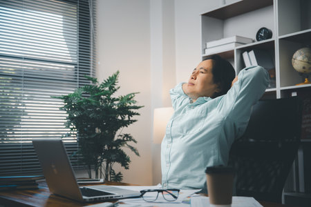 Stress business woman person from hard work, depression in office. Tired and anxious employee female with unhappy at problem job. young businesswoman sitting sad front of laptop computer on desk.の写真素材