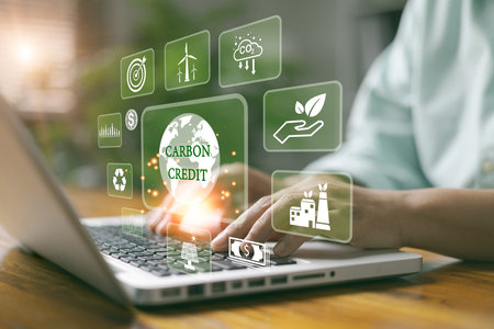 Carbon credit market concept. Green energy, Businesswoman with Carbon credit icon. Net zero in 2050 year. Green energy icon around it. Carbon Neutral in industry Net zero emission eco energy.の写真素材