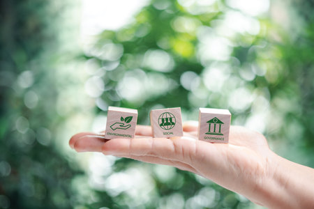 Hand holding wooden cubes. ESG Concepts on Environment, Society and Governance green wooden block icon esg investment esg sustainable corporate development environmental consideration.の写真素材