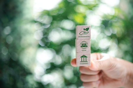 Hand holding wooden cubes. ESG Concepts on Environment, Society and Governance green wooden block icon esg investment esg sustainable corporate development environmental consideration.の写真素材