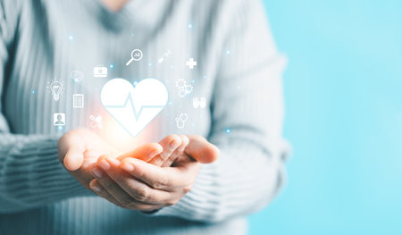 Woman hand holding heart shape for technology healthcare medical icon. access to welfare health and copy space, medical health care with medical network connection, Health insurance health concept.の写真素材