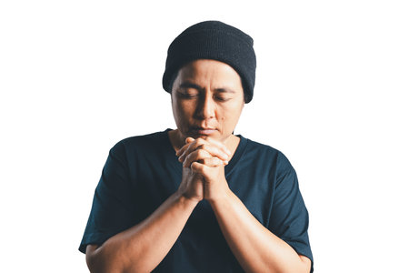 Woman who believes in god with person hands praying on isolated white background. Asian woman stands in meditative pose, holds hands in praying gesture, has sense of inner peace, Religion concept.の写真素材