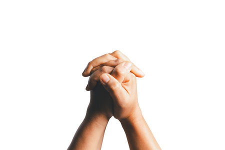 Female hands praying on a white isolated background, Asian woman stands in meditative pose, holds hands in praying gesture, has sense of inner peace, Isolated praying hands, Religion concept.の写真素材