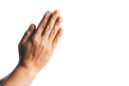 Female hands praying on a white isolated background, Asian woman stands in meditative pose, holds hands in praying gesture, has sense of inner peace, Isolated praying hands, Religion concept.の写真素材