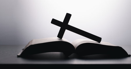 Bible with wooden cross on White Background. Holy book. Black and white photography. wooden cross...