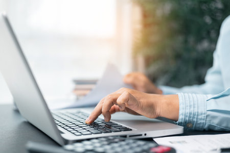 Business woman working on documents looking concentrated with briefcase on table. Businesswoman is deeply reviewing a financial report for a return on investment or investment risk analysis.の写真素材
