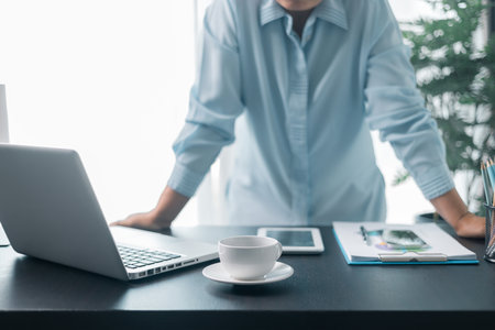 Female entrepreneur working in home office at her desk. Business woman entrepreneur in office using laptop at work, professional middle aged female company executive working on computer at workplace.の写真素材