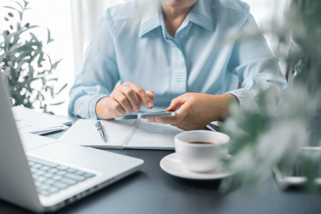 Female entrepreneur working in home office at her desk. Business woman entrepreneur in office using laptop at work, professional middle aged female company executive working on computer at workplace.の写真素材