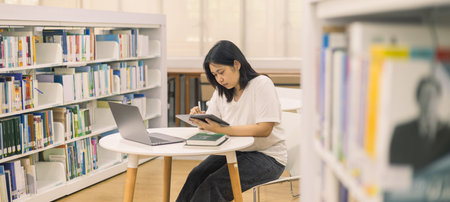 Young student eagerly enters the classroom, ready to immerse themselves in world of learning and education at college, studying books alongside their peers in university.の写真素材