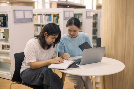 Two young woman, a dedicated student, navigates university life with her friend, embracing education...