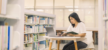 Young student eagerly enters the classroom, ready to immerse themselves in world of learning and education at college, studying books alongside their peers in university.の写真素材