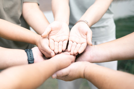 Diverse group came together to pray, support, and help each other, showcasing the strength of community through their diverse backgrounds and unified hands. Group Christian pray concept.の写真素材
