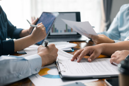Financial analyst presented a detailed data analysis graph to their colleague, corporate office, demonstrating the business's financial status and trends. Concept of business data analysis.の写真素材