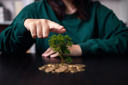 Concept of financial growth involves wisely investing money to save, accumulate wealth, metaphorically nurturing it like tree, coin representing business opportunity. Finance, investment, environmentの写真素材