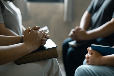 Group of Christian women sat together in chairs, holding their Bibles, feeling the togetherness of...