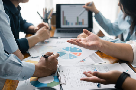 Financial analyst presented a detailed data analysis graph to their colleague, corporate office, demonstrating the business's financial status and trends. Concept of business data analysis.の写真素材