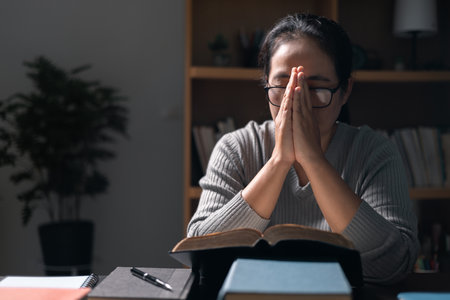 Woman with Bible in her hand, her faith unwavering as she prayed and worshiped God, finding strength and guidance in her Christian religion through the holy book. pray, woman, bible, faith, religion.の写真素材