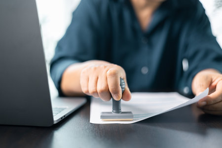 Banking officer stamped the document to approve the loan, finalizing contract and solidifying the...
