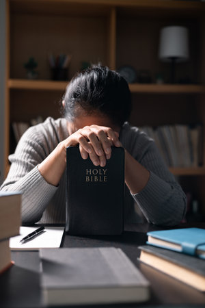 Christian woman spent her evenings reading and studying Bible, deepening her faith and understanding...