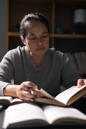 Woman with Bible in her hand, faith in God strengthened by holy words of book, found solace and inspiration through prayer in her Christian religion. bible, woman, book, religion, christian, holy.の写真素材