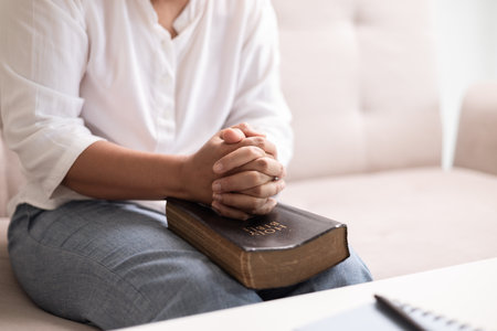 Christian woman with faith and hope, raises her hand in worship to pray to God and Jesus Christ, embodying her religion. woman, hand, faith, pray, worship, jesus christ, christian, god, hope.の写真素材