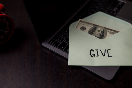 Carefully budgeting her money, she placed cash into separate envelopes for giving, business...