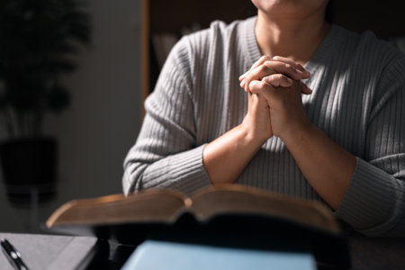 Woman with Bible in her hand, her faith unwavering as she prayed and worshiped God, finding strength...