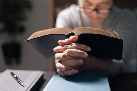 Woman with Bible in her hand, her faith unwavering as she prayed and worshiped God, finding strength and guidance in her Christian religion through the holy book. pray, woman, bible, faith, religion.の写真素材