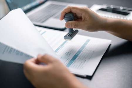 Banking officer stamped the document to approve the loan, finalizing contract and solidifying the...