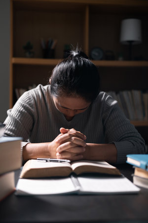 Woman with Bible in her hand, faith in God strengthened by holy words of book, found solace and inspiration through prayer in her Christian religion. bible, woman, book, religion, christian, holy.の写真素材