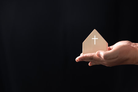 Modern church building, with a cross prominently displayed, serves as a place of worship for the Christian community, blending the traditional Catholic faith with a contemporary home-like background.の写真素材