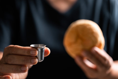Sacred ceremony of Communion, Christians express their faith by partaking in holy bread, deepening their spiritual connection with God within the church. communion, religion, christian, faith, holy.の写真素材