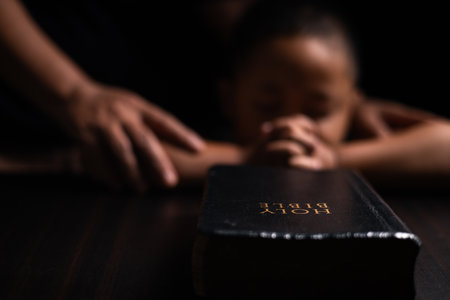 A mother teaches her child about Jesus Christ and the Christian faith, reading the Bible together and nurturing his belief in God. child, jesus christ, bible, christian, mother, person, faith, boy.の写真素材