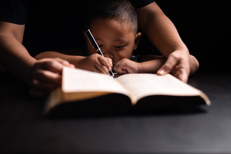 A mother teaches her child about Jesus Christ and the Christian faith, reading the Bible together and nurturing his belief in God. child, jesus christ, bible, christian, mother, person, faith, boy.の写真素材