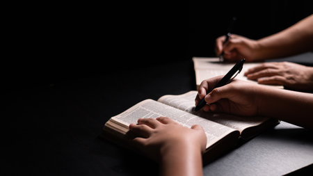 Bible in hand, a Christian prays with faith and hope, seeking guidance from God and the teachings of Jesus Christ in the gospel. hand, bible, faith, gospel, christian, god, prayer, religion, hope.の写真素材