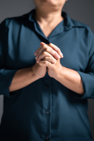 Woman raises her hand in prayer, with deep faith in God, worshiping Jesus Christ in a moment of holy peace and devotion. woman, hand, pray, faith, religion, jesus christ, christian, god, holy.の写真素材