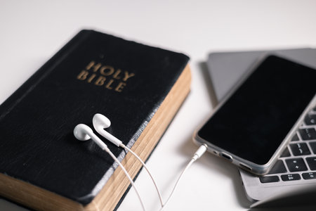 Digital age, many people now worship online, merging faith in God with technology to pray and read the Bible from the comfort of their homes. faith, god, holy, religion, worship, technology, bible.の写真素材