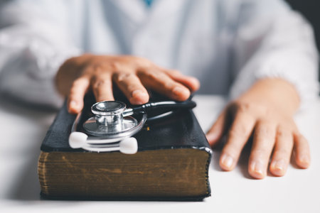 Doctor clasped their hands in prayer, hoping for the best as they provided medical care in hospital clinic. doctor, pray, medicine, health, medical, hand, hospital, care, clinic, hope, prayer, person.の写真素材