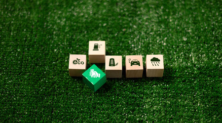Wooden cube symbolizing renewable energy, sustainable practices sits concept piece for green, eco-friendly future on Earth, promoting environmental, ecological awareness. eco, renewable, sustainableの写真素材